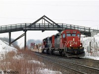 CN SD40-2 5385 and SD75I 5787 head an eastbound intermodal under the old wooden bridge at Frank's Lane on the Strathroy Sub at Lobo Siding (the name of a hamlet just west of London).