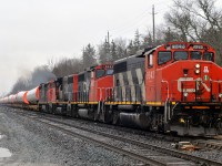 CN 9543, CN 9482, CN 9427, and CN 2442 bring L30721 14 through Hardy with 72 cars on a rainy March afternoon. 2442 had a traction motor catch fire on the Copetown hill, so L580 was dispatched to assist them to the south service at Paris