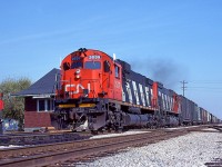 Getting 'er done, Windsor-bound CN Extra 2039 West pounds the rails as it blows by the old Thamesville station at mile 46.5 on the CN's Chatham Sub. Trailing unit is the CN 2326.