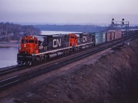 CN C630m units 2009 and 2016 lead an eastbound from Hamilton and Niagara through Bayview at dusk on a spring evening in 1968.