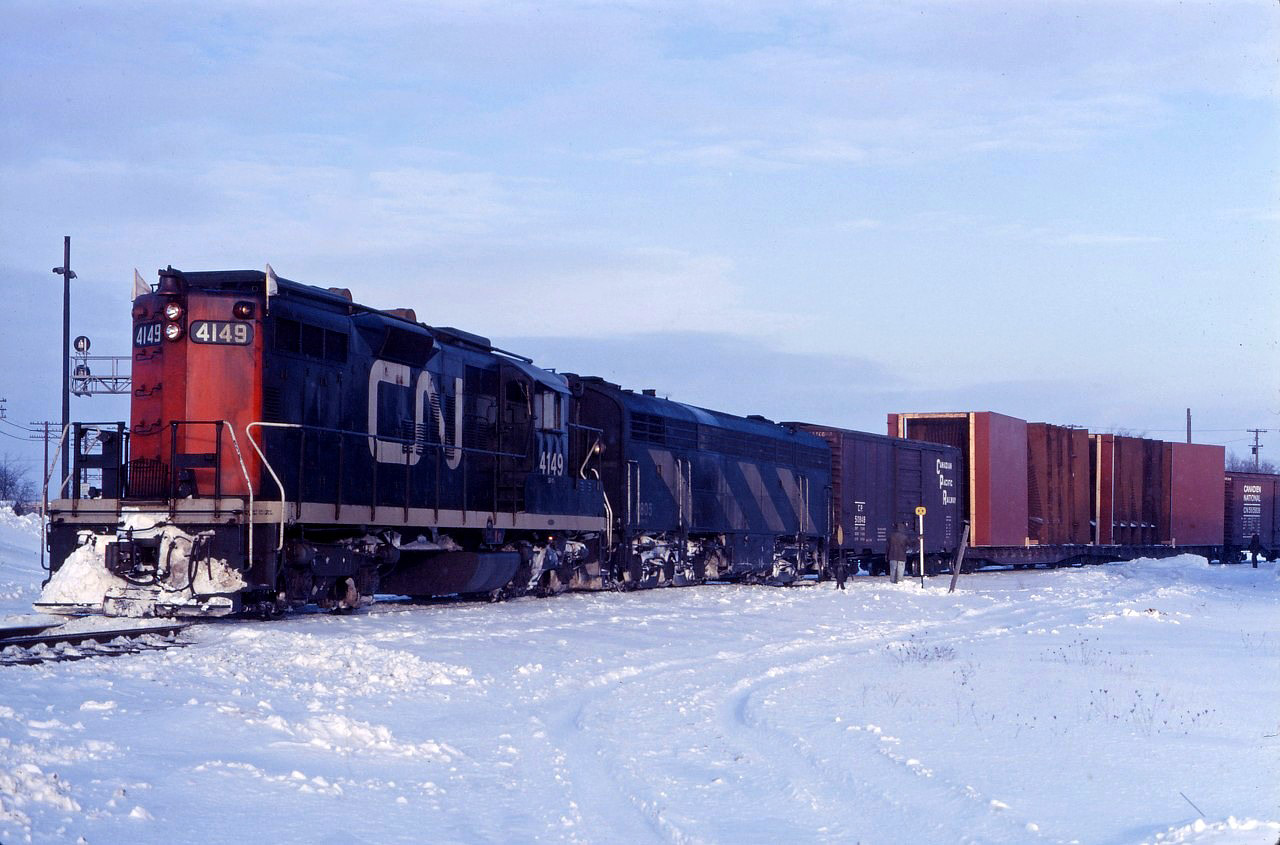 A freight works the west leg of the wye in Burlington in early 1969. Note the dimensional load cars and the crewman "on the ground", as well as the interesting GP-9 4149/CPB-16-5 lashup!