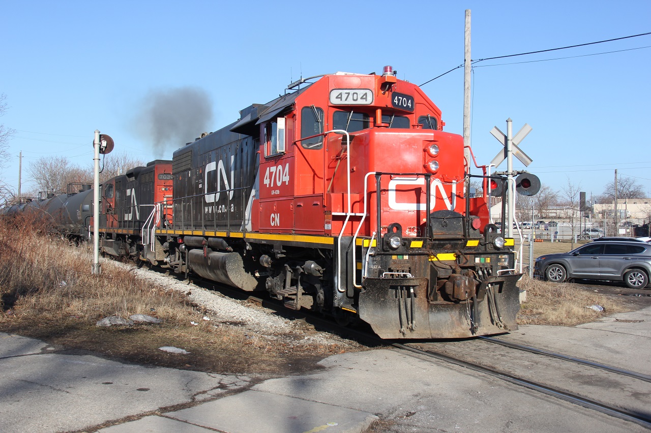 Work may have brought me down to Hamilton's Industrial Core, but the sun brought me out exploring. With a window of opportunity, I finally got a decent chance to explore the industrial core and check for trains down in "the hole." I have never ventured in this territory and I had no guide. I have been in the area a handful of times for work but never had a chance to explore and shoot trains. It is very convoluted (much like the abandoned factories I did work in!). I have a few more shots to post in time. I'll start with a familiar one. The CN local (don't know the symbol) with 4704 and 7038 is seen finished its duties down in the hole and returning to Stuart St. Yard, crossing Simcoe St. E. I like the tiny searchlight signal. The crew may have revved up the engines for my shot as they opened them up as soon as I popped out for my shot. I also realized that other RP.ca contributors shot this location but from the Ferguson Ave. bridge.