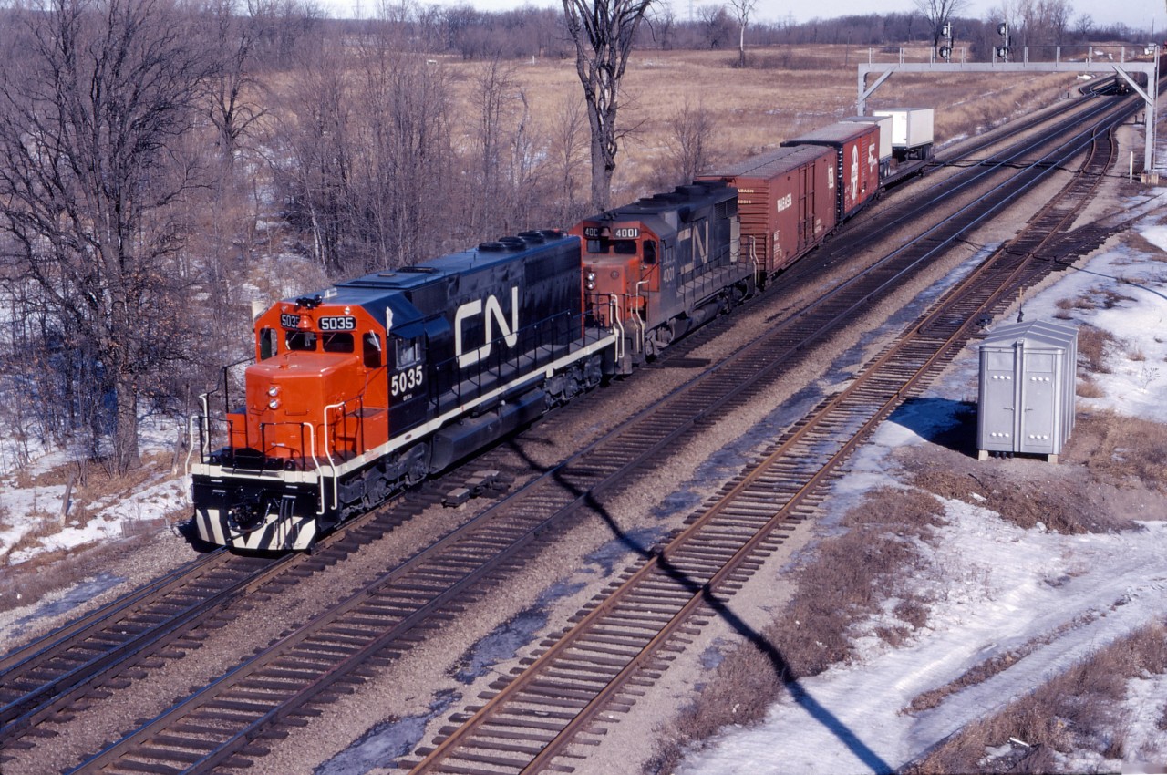 CN SD40 5035 and GP35 4001 work Aldershot yard in February 1968. The 5035 was built in early 1968 and may be on one of its early "shake-down" runs; the 4001 was built in August 1964 and was one of only two such units on CN. (The current GO station and parking lot would be to the north of the units in this view taken from the Waterdown Road bridge.)