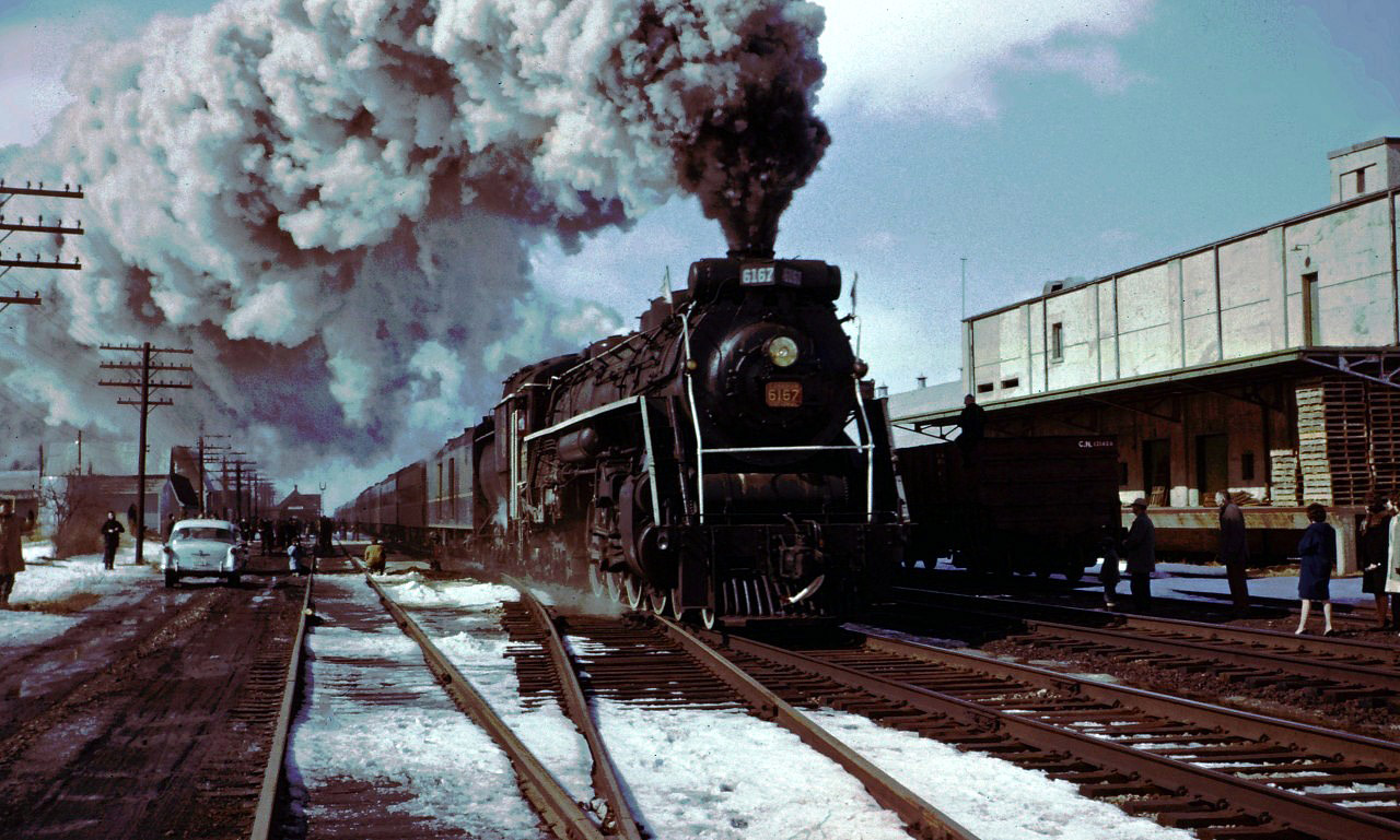 On March 4, 1962 CN and the UCRS sponsored an excursion between Toronto and Niagara Falls. Here we see the train at Aldershot--note the station building with train order signals on the north side of the tracks (it was still movement by signal indication Rule 251 territory--ABS in 1962) and the cold storage building on the south side of the train. Viewed from today's perspective, it seems amazing that enthusiasts and the general public would be allowed all over a "live" railway back then.