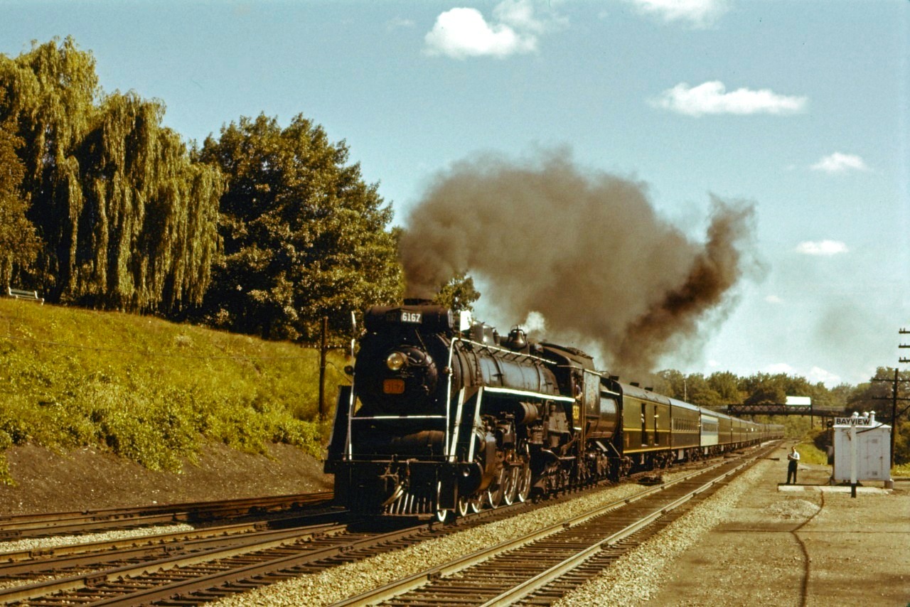 CN 4-8-4 6167 leads a joint CN/UCRS excursion train through Bayview on its way to Niagara Falls. Note the second coach (5515) which is in an "experimental" paint scheme, one of three cars painted this way before black was adopted...unfortunately, it is "up front" in the consist!

Perhaps one of our members can identify the fan in the photo.