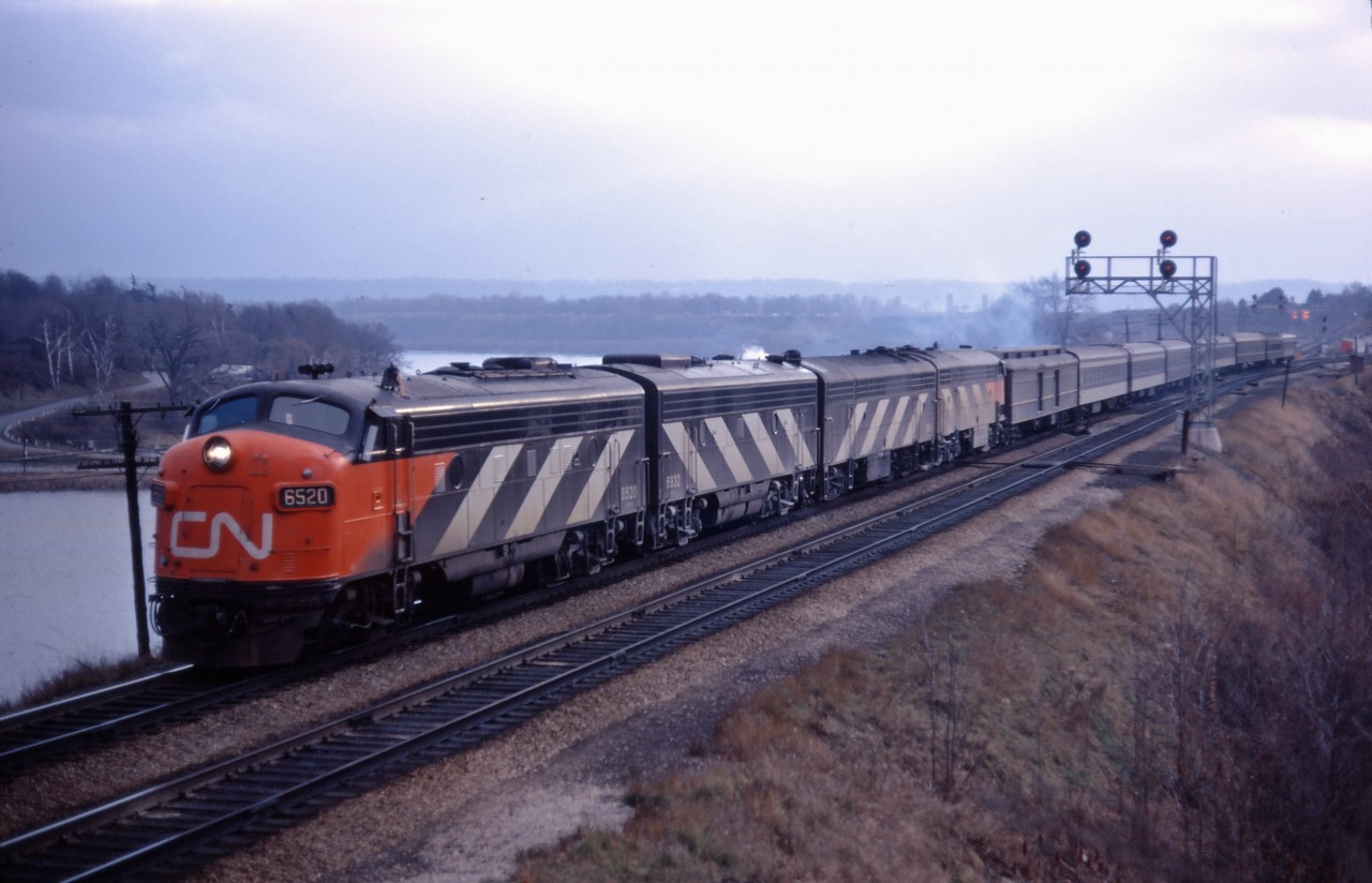 FP9 6520, F9B 6632, and an unidentified CPB16-5/CPA16-5 combination lead an eastbound train through Bayview on a dull day in late 1967 or early 1968 (this Kodachrome slide processed January 1968). While passenger locomotives have largely been repainted into the "new" CN scheme, four of nine cars in this train are still the 1954 green and black paint--including two clerestory roof cars; older cars such as these would start to be retired in the early 1970s as CN began to retreat from aggressive passenger train marketing.