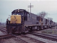 Making my usual Sunday morning rounds, (Bayview/Burlington then Guelph Jct), I stopped by Burlington station where I was informed by CN operator Bruce Mercer of a C&O detour train operating over CN's Dunnville sub from Fort Erie to Canfield! The reroute was necessitated by a "laker" hitting pilings (caissons) at the Welland drawbridge and the bridge was awaiting inspection by structural personnel. The train is seen crossing the Canada Southern mainline and will enter CN's siding before backing onto the NYC to continue westward. Likely combined trains SC-5 and BDC-3 with 77 cars and 5 units, U25Bs 2521, 2506, 2523, and 2536 with GP30 3023 in fourth position. (With supplementary information from Bruce Mercer.)