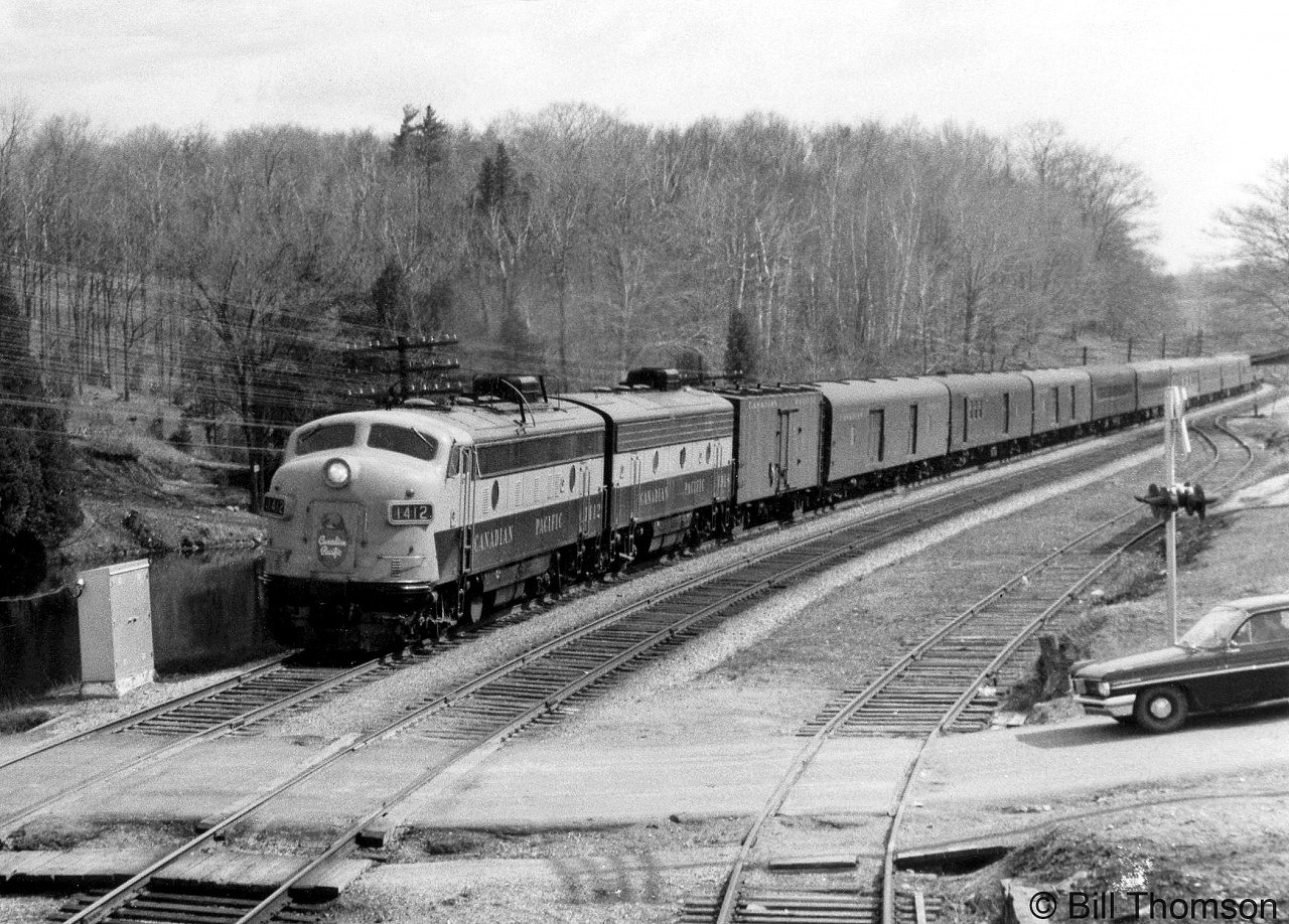 Another view of the last run of CP #21 "The Chicago Express", a Montreal-Toronto-Windsor-Detroit full-service train that featured parlor and dining car service as well as a through sleeping car, the day before it and train #22 were replaced with "Dayliner" service using RDCs. CP FP9 1412 leads an F7B and #21's passenger consist through Campbellville, about to cross Guelph Line crossing as traffic waits for the train to pass.

Other shots of the train on the same day:
Head-end going away shot: http://www.railpictures.ca/?attachment_id=25072
Tail-end going away shot: http://www.railpictures.ca/?attachment_id=25358
Stopped at Guelph Junction: http://www.railpictures.ca/?attachment_id=24875