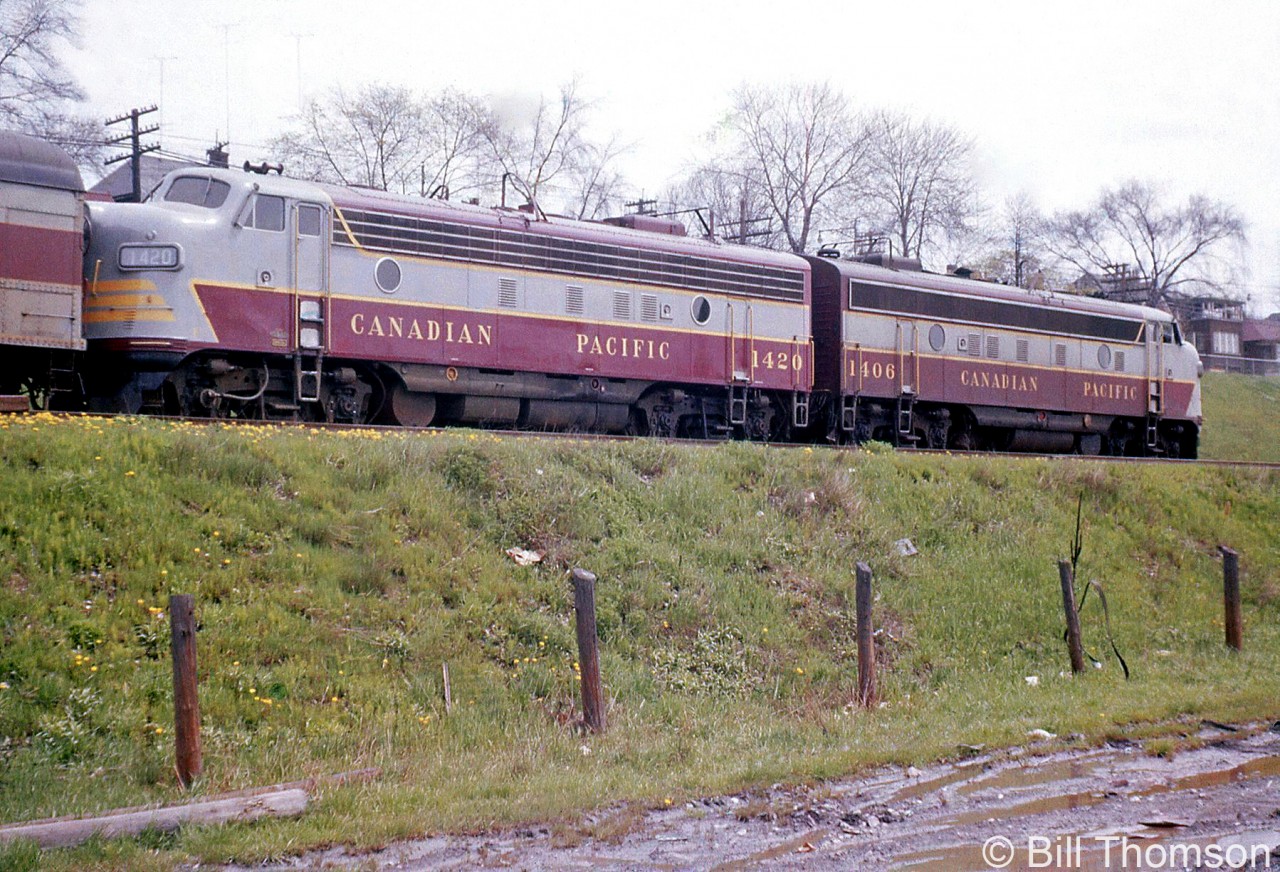 CP FP7 1420 and FP9 1406 lead train #732, stopped at CN's Sunnyside Station in 1956. At the time, you could park right beside the then-newly opened Gardiner Expressway.  CP Train #726 (later renumbered as train #326 by 1959) was one of the daily passenger trains CP operated between Hamilton and Toronto, departing the TH&B's Hamilton Station and running over the Hamilton Sub to Hamilton Junction, before operating via running rights over CN's Oakville Sub east to Toronto's Union Station.

Timetables show the train was scheduled to depart Hamilton at 2:10pm, stop at Sunnyside at 2:59pm, and arrive at Union at 3:10pm (with a flag stop at Oakville at 2:36pm if required).