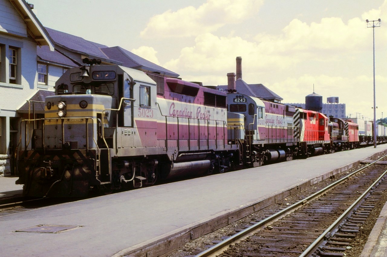 A westbound CP freight pauses at Sudbury, Ontario for orders on July 26, 1969 with an interesting array of locomotives. Back in the late 1960's, lash ups like this were common in Northern Ontario. Units are: 5023 4243 5007 8453 and 4404.