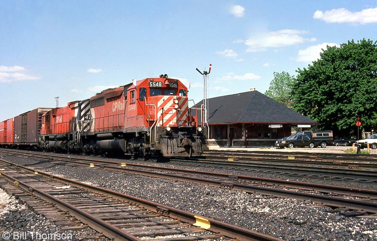 CP 5548 West with SD40 5548 leading a 4700-series M636 passes by Woodstock Station on a sunny Wednesday in May of 1985 (note the semaphore signals still present).