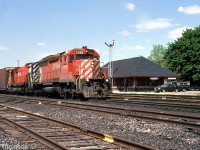 CP 5548 West with SD40 5548 leading a 4700-series M636 passes by Woodstock Station on a sunny Wednesday in May of 1985 (note the semaphore signals still present).