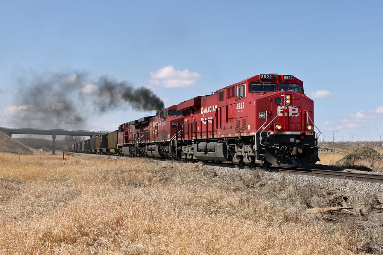 This picture taken by my son Jason. ES44AC CP 8922 and a pair of AC4400CWs 9623 & 9811 head south under 32nd Street, Okotoks, with the second unit doing it's bit to add to air pollution. The train is coal gondolas almost entirely BNSF.