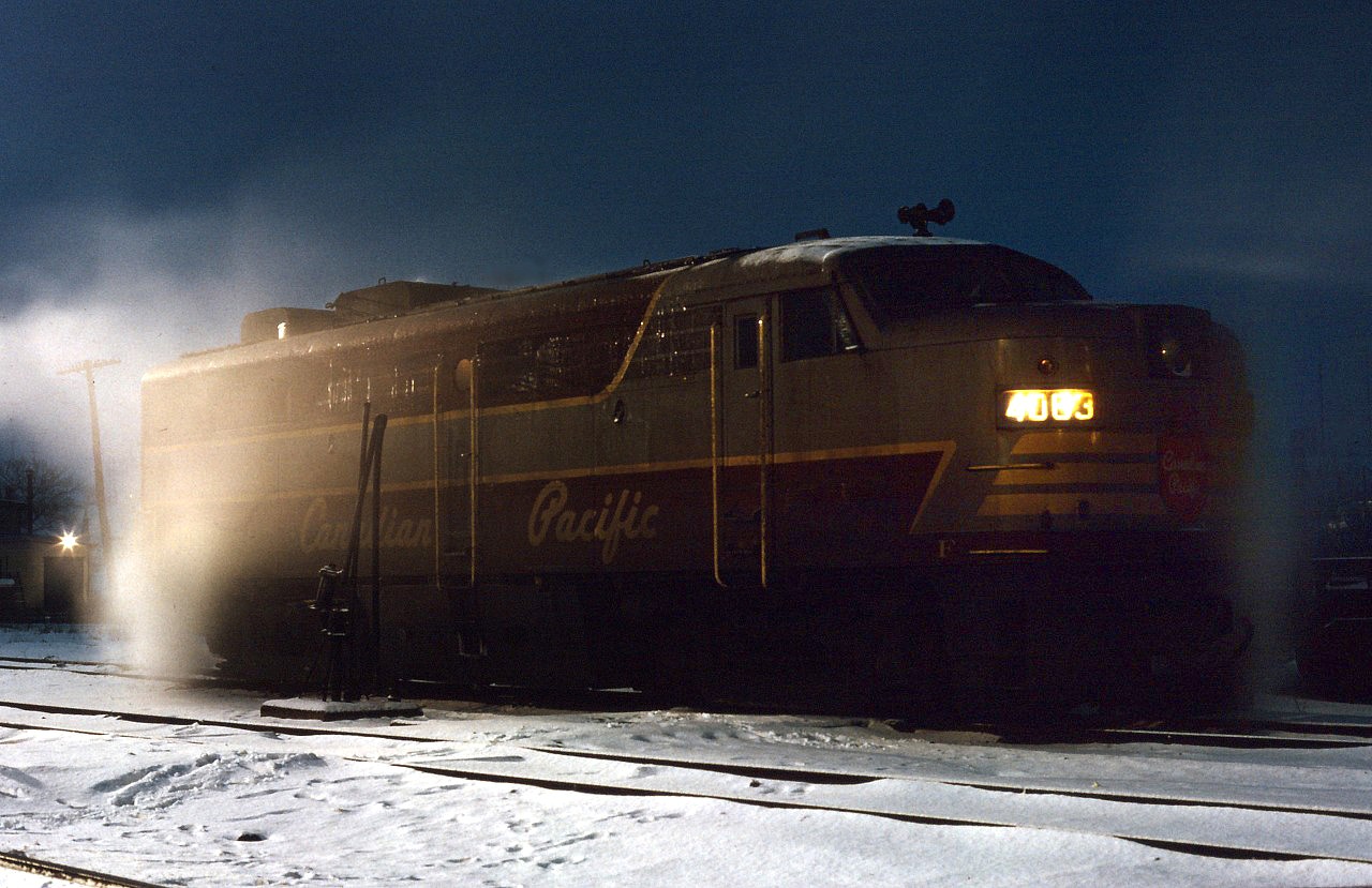 Surrounded by leaking steam, Canadian Pacific FPA2 4083 idles the night away at the TH&B's Chatham Street roundhouse in Hamilton. Having brought CP's part of the Toronto Hamilton & Buffalo line train to New York over to Hamilton mid-evening, it will take the New York-Toronto train back to Toronto first thing in the morning, trading off with TH&B or NYC power at the Hunter Street station.