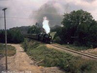 Another image of the <a href=http://www.railpictures.ca/?attachment_id=33872><b>NRHS Buffalo Chapter excursion</b></a> using two CPR D10's, this time 1098 and 1092 are shown heading northbound on the Orangeville Sub at Charleston Sideroad, north of Cataract in Caledon, possibly doing a run-by. The train is about halfway on its trip from Streetsville north to Orangeville. According to mid-1950's aerial imagery, Charleson Sideroad originally passed under the Orangeville Sub where the two D10's are, sometime before the alignment here was shifted north to the present-day elevated road overpass (the old alignment was renamed Quarry Drive). This shot was either taken from a nearby hillside, or possibly an embankment of the overpass (the access road in the foreground wasn't present a few years earlier, so could have been a construction access road).
<br><br>
This was another old Ektachrome that had badly colour-shifted and required a fair bit of tweaking to restore. It didn't have any location or photo details other than the process date stamp, but having shot the Orangeville-Brampton Railway here before I recognized the spot.
<br><br>
<i>John Wagner photo, Dan Dell'Unto collection with some editing and cleanup work.</i>