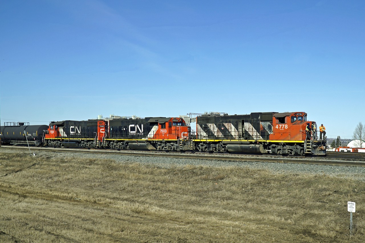 GP38-2(W) CN 4778 and GP38-2s 7503 and 7530 are switching oil tank cars at the east end of CN's Clover Bar yard.