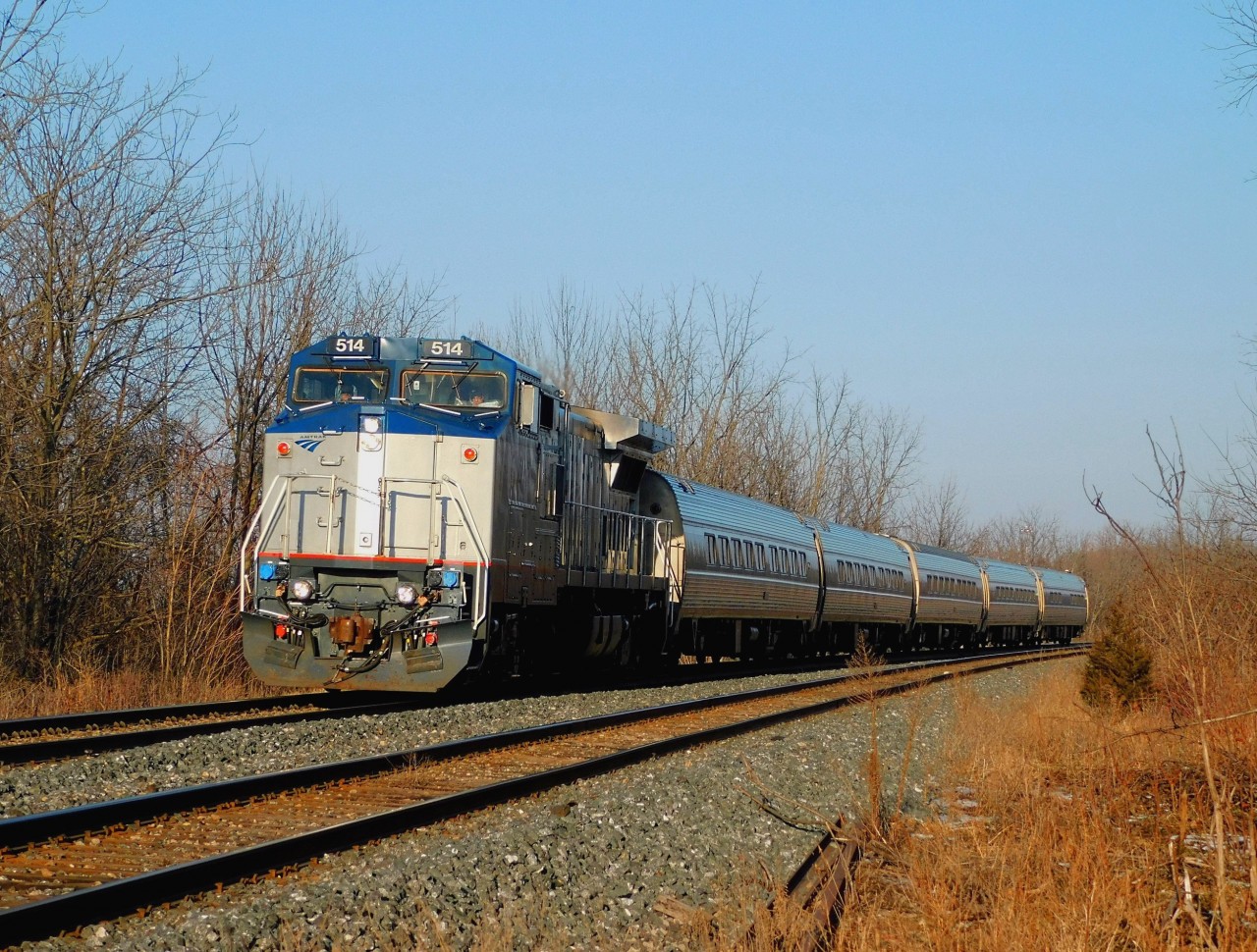 VIA 98 rounds the curve with Amtrak Dash 8-32BWH 514 as it quickly approaches the Garner Road crossing on the Grimsby Sub as it makes its way west towards Toronto after leaving the Niagara Falls VIA station several minutes prior.