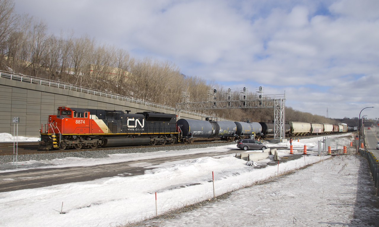 With an SD70M-2 up front and another 101 cars back (CN 8874 and CN 8881), a 141-car CN 305 slowly departs Turcot Ouest after a quick crew change, with the inbound crew performing a roll-by inspection on the train.
