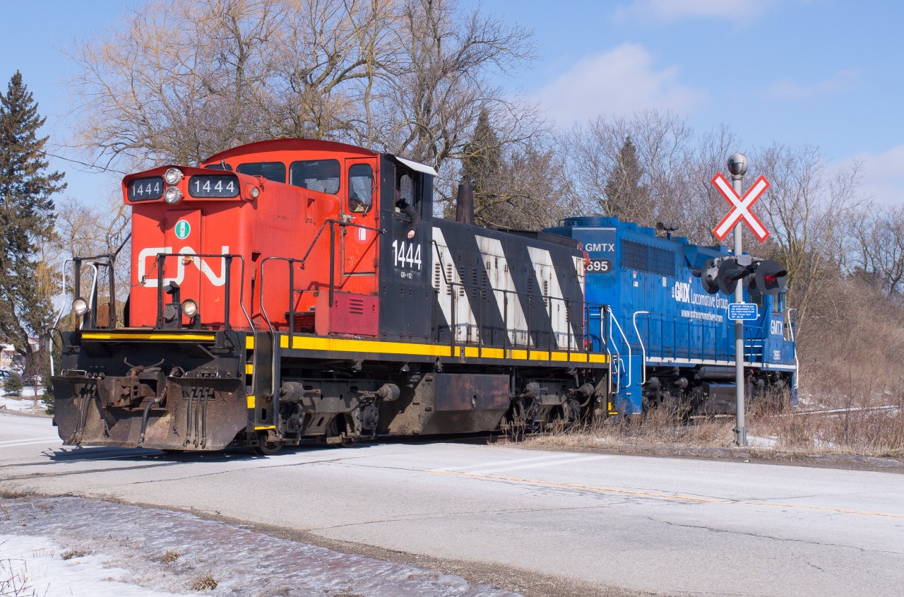 CN 1444 and GMTX 2695 ease across Wellington Road 32 outside of Guelph as they head back towards Preston.