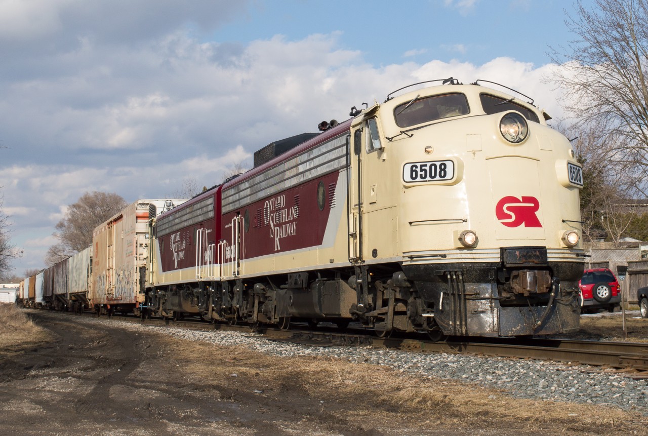 The Woodstock Job slows to set off their cars at Ingersoll amid a brief moment of sunlight in a fairly cloudy afternoon.  Tasked with the train today is the attractive pair of matching F Units that I always enjoy coming across.