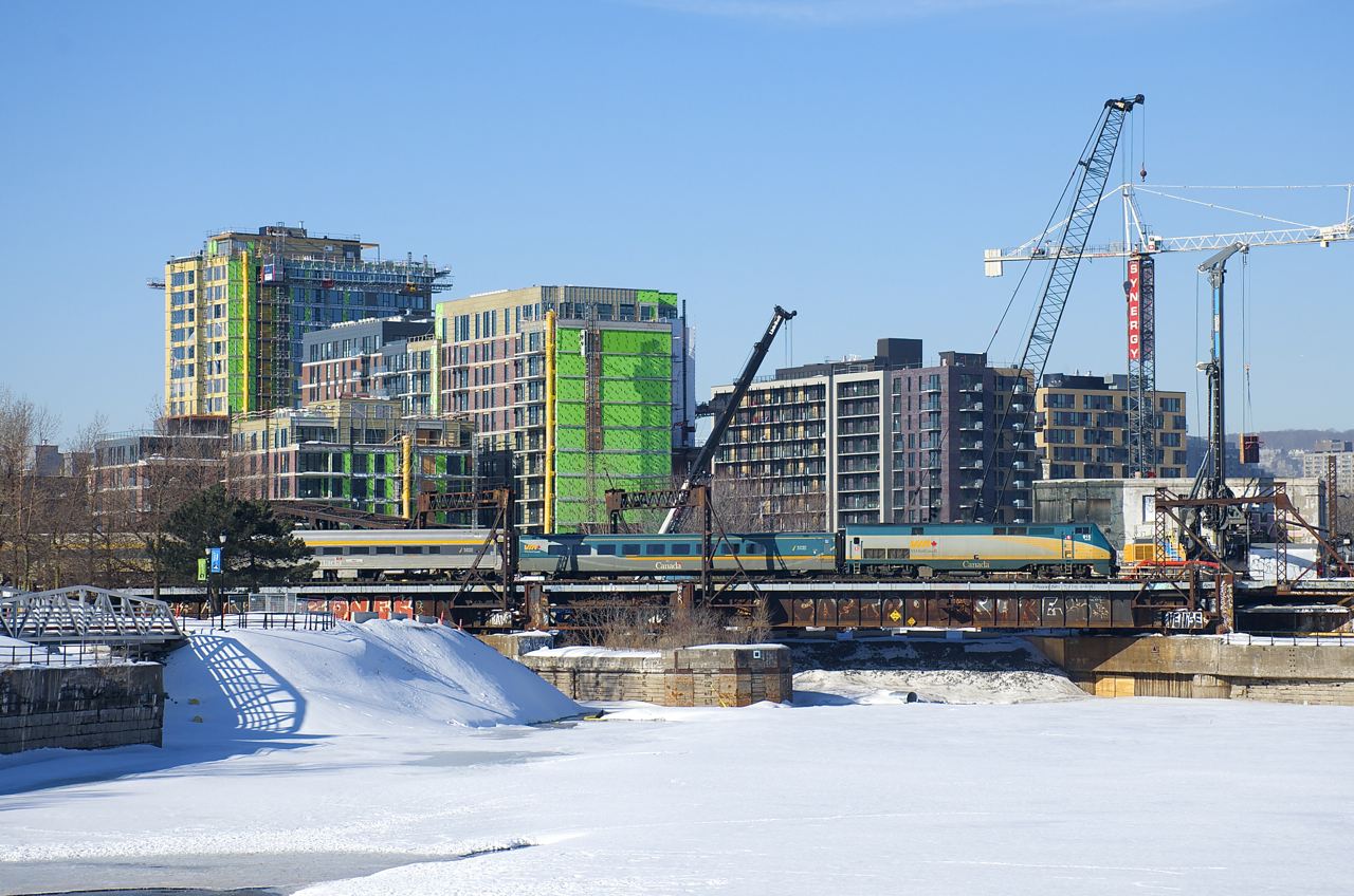 Cranes are everywhere (for new condos, as well as for construction for the REM light rail project) as VIA 22 passes Wellington Tower as VIA 915 pushes the train towards Cape, where it will reverse and then head towards Quebec City.
