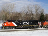 Nearly brand new Tier 4 credit unit CN 3843 leads CN 305 through St-Henri, its spotless appearance in contrast to the grimey CN 2618 which is trailing.