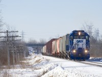 The only freight train that serves the city of Ottawa and surrounding areas (CN 589) is leaving Ottawa for a run down to Coteau after letting VIA 35 and then VIA 26 pass. Leased GP38-2 GMTX 2260 has about fifteen cars in tow as the train starts to pick up speed.