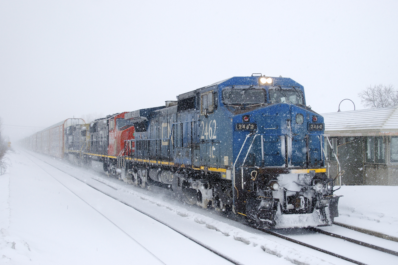 CN 372 has 91 autoracks and IC 2462, CN 5739 & GECX 7353 for power as it passes through Dorval on a very snowy morning.