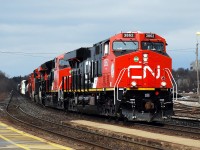 Shiny and new CN 3862 and CN 3171 brighten up an otherwise dull day leading a westbound through Brantford.  I lucked out with a brief appearance of the sun, you can see the impending gloom a few cars back in the train.  With my luck it's usually the sunshine that's a few cars back! 