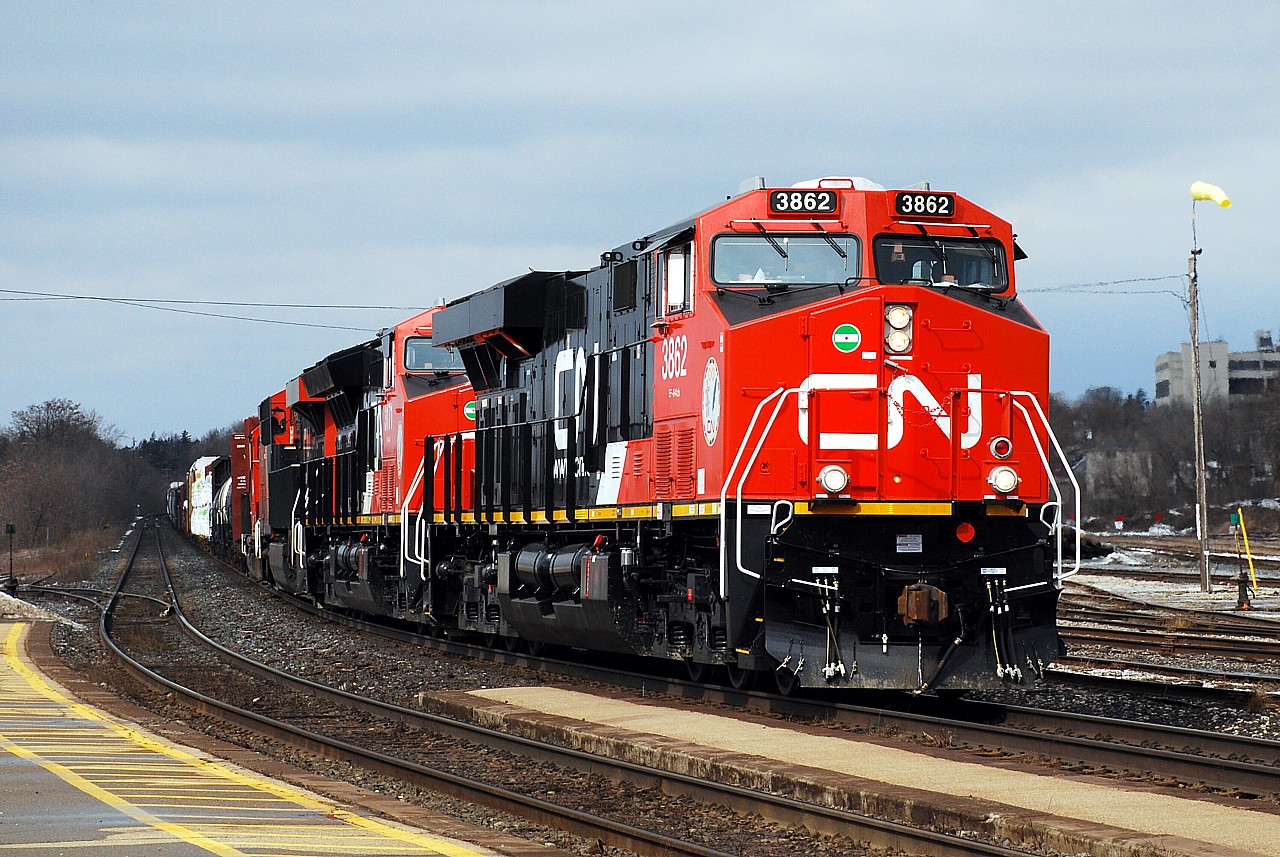 Shiny and new CN 3862 and CN 3171 brighten up an otherwise dull day leading a westbound through Brantford.  I lucked out with a brief appearance of the sun, you can see the impending gloom a few cars back in the train.  With my luck it's usually the sunshine that's a few cars back!