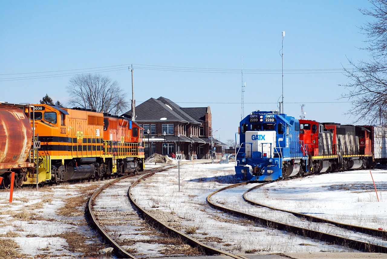 Hot times at Stratford West.  GEXR 581 comes off the GEXR Goderich Sub. and enters the CN Guelph Sub. as CN L568 sets off cars in the yard for the Goderich-Exter.