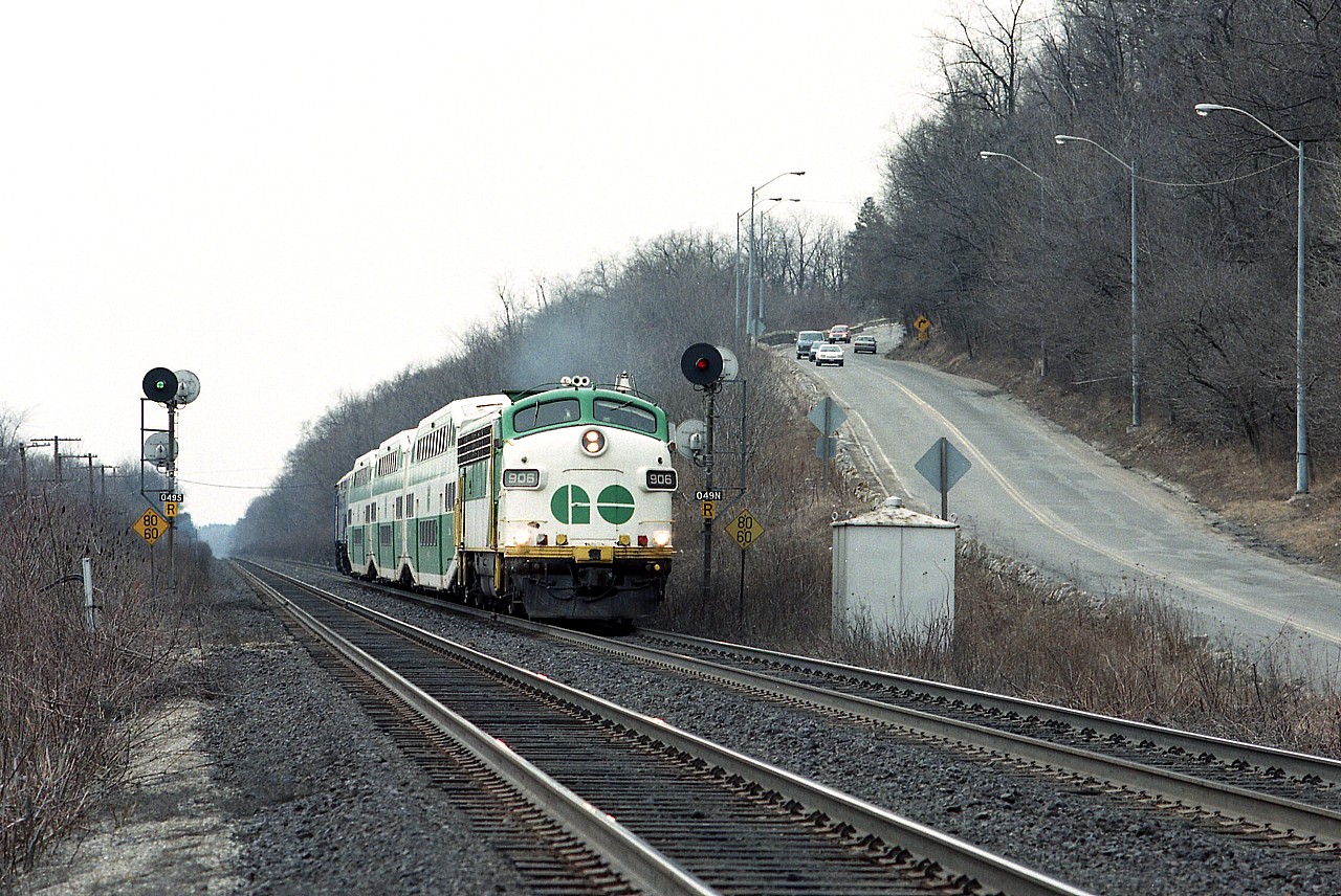 Running eastward, north track, splitting the signals at mile 4.9 Dundas Sub  we see an odd combination of GO 906, Bi-levels and VIA 6412 on the rear.  This odd combination and many like it were on account a broken axle on an LRC coach, and as a result all LRC coaches came off for emergency repairs leaving VIA scrambling for cars. So numerous GO bi-levels were pressed into service. On the right is old Hwy 8 snaking up the hill towards West Flamborough. Hard to believe this collection is VIA #72.
