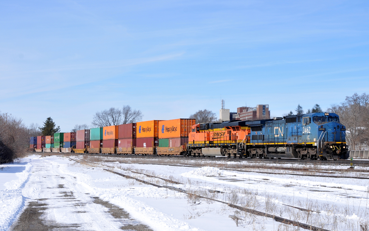 IC 2462, and BNSF 6145 lead on CN Q14891 28 with 128 cars