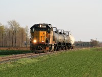 With spring in the air, LLPX GP38-2 2236 leads Goderich-Exeter Railway (GEXR) train 584 to Elmira on the Waterloo Spur having just crossed Highway 85 north of St. Jacobs. The train has five tankers destined for the chemical facilities at the end of the line in Elmira.