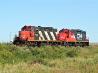 CN GP9RM's 7246 and 4118 roll westbound through Mansewood on the Halton Subdivision. At the time, 7246 was just freshly repainted and certainly looked good in the evening light. 
