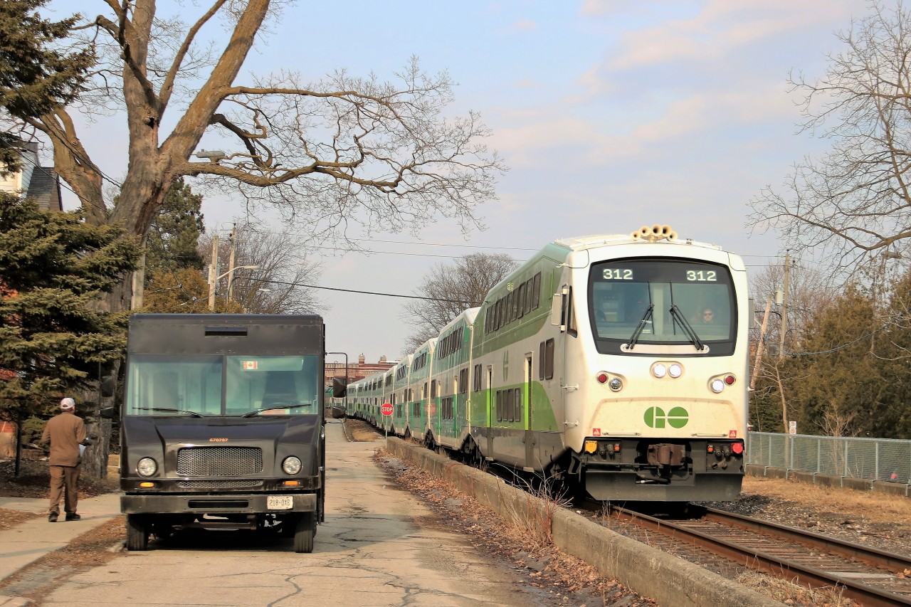 After making its stop at the Guelph GO station, GO 312 slowly runs along Kent Street on its way to Kitchener as the UPS truck makes a delivery.