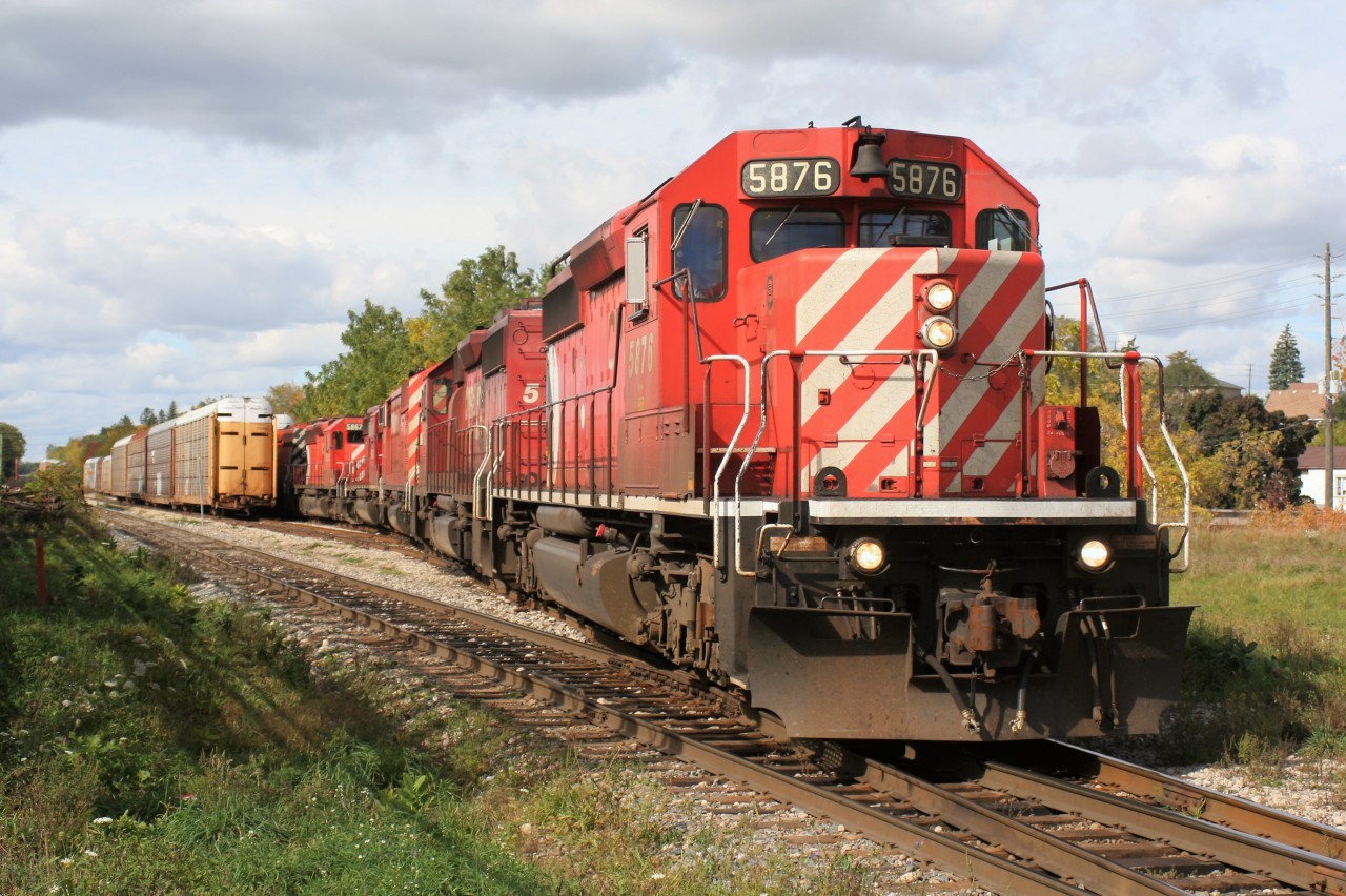 An eastbound Canadian Pacific train is viewed lifting loaded auto racks in Galt on the Waterloo Subdivision near Hespeler Road that were sitting on track WG–32 North. This area was drastically changed with the installation of the Hesepler Road overpass years later.

The consist includes; SD40-2 5876, SD40-2 5788, SD40-2F 9012 and SD40-2’s 5990, 5867 and 5763. Once the lift is completed, the units and cars will return to their waiting train by the Galt station and continue the journey east to Toronto. October 10, 2009.