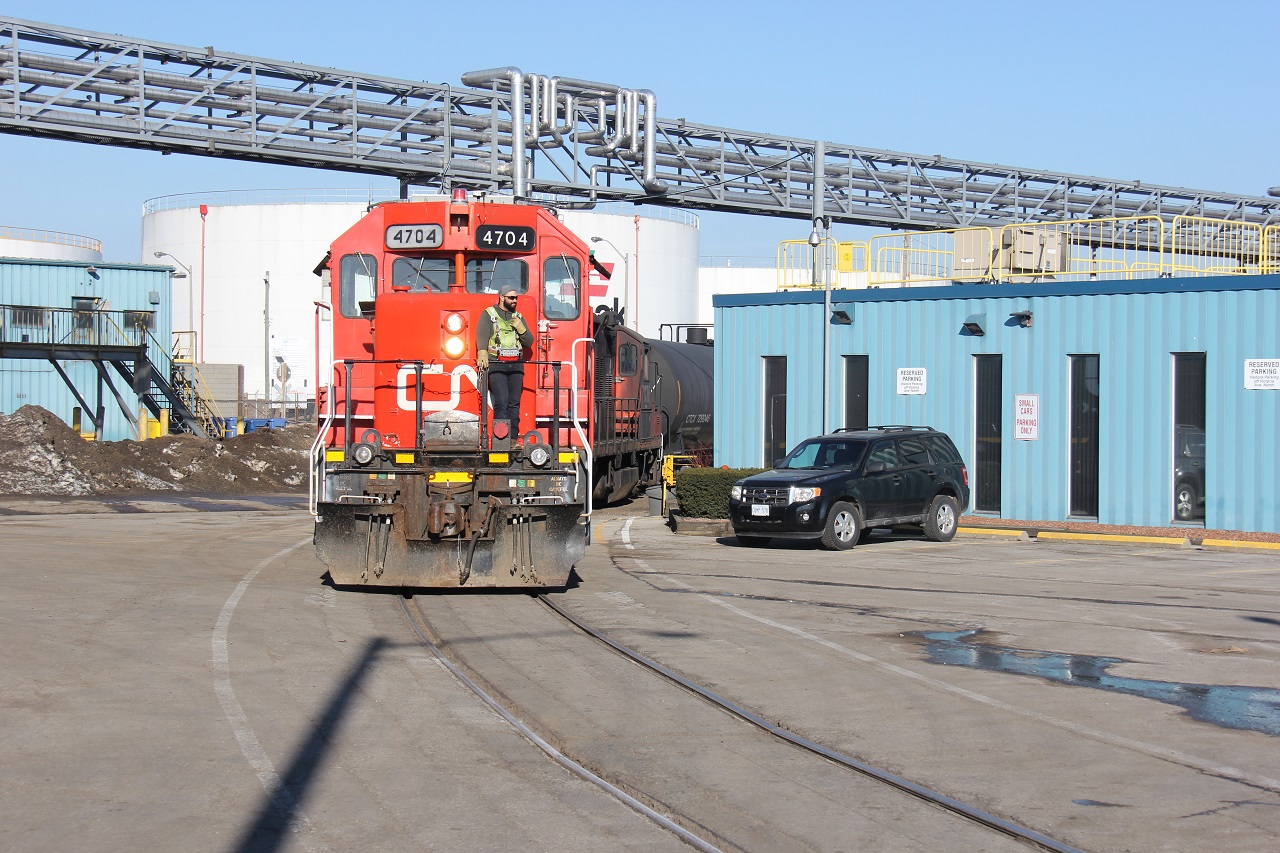 CN 4704 and CN 7038 are pictured pulling ahead out onto busy Burlington St. E. in Hamilton's industrial core during switching at Vopak at the end of Victoria Ave. on one of the first real nice days so far in March. I happened upon this train for the first time scoping out train shots in this area. The radio gave me some indication that there was a train somewhere down in "the hole". I just had to track it down. I also caught this symbol working Stelco the following day and had a money shot in my eyesight but because of tight security and a strict no photography rule (I was inside on the property and there for work) and not being prepared as I was driving (in a convoy too!), unfortunately it couldn't happen. I was very disappointed. I still regret not taking the risk! All for train shots right?