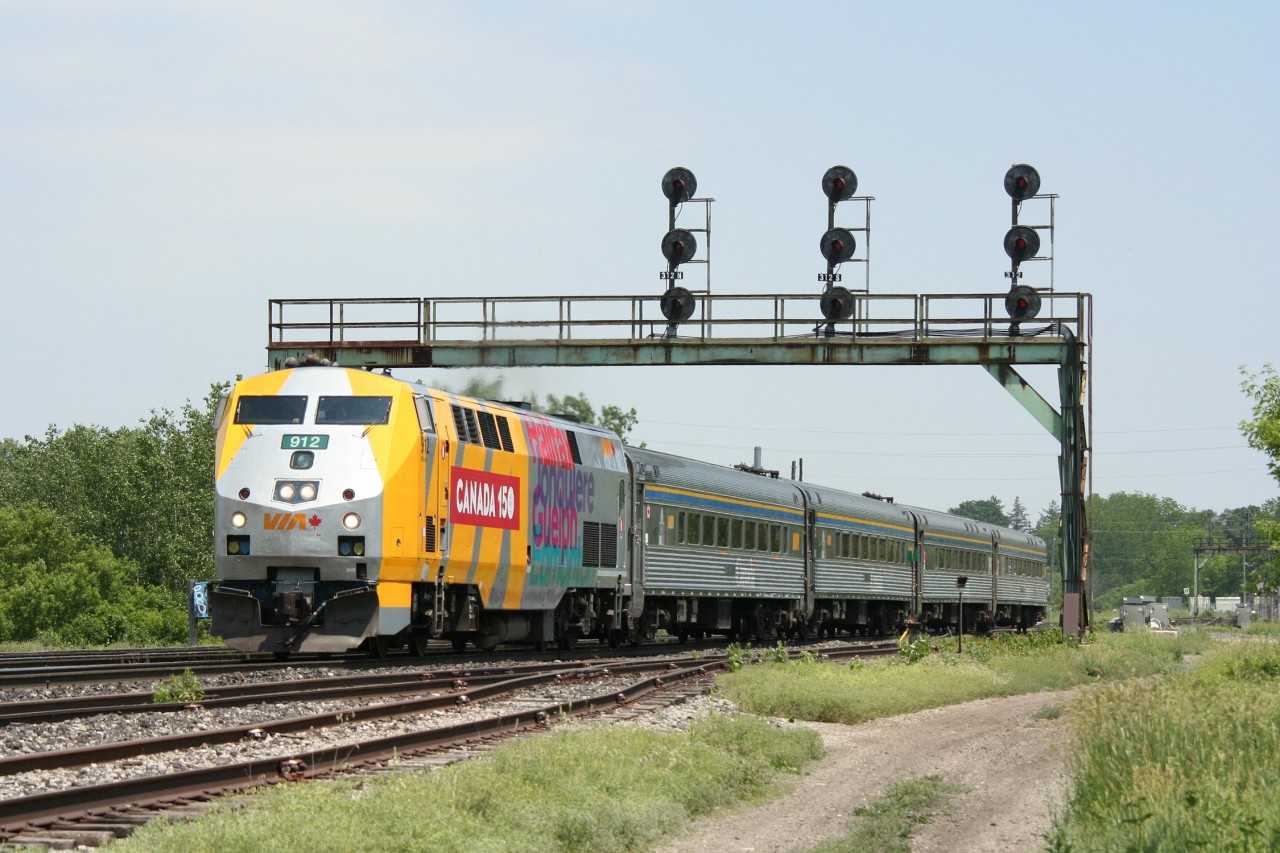 VIA P42DC 912 in the Canada 150th Anniversary wrap leads a westbound train through Paris.