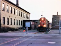 The 15:30 Kitchener Job with GP9RM 4134 is seen approaching Regina Street in downtown Waterloo on the evening of May 6, 1993. The crew has lifted no cars on their southward trip along the Waterloo Spur and will return to Kitchener with just their unit.