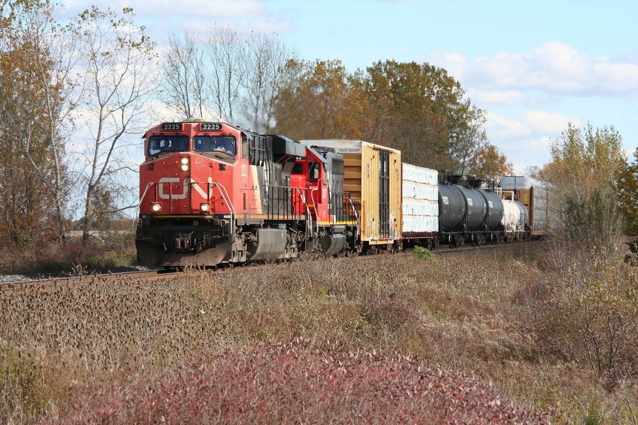 Westbound approaches Sarnia with an IC GP40-2 in CN paint in the trailing position.