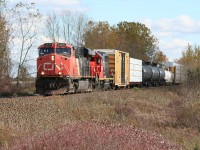 Westbound approaches Sarnia with an IC GP40-2 in CN paint in the trailing position.