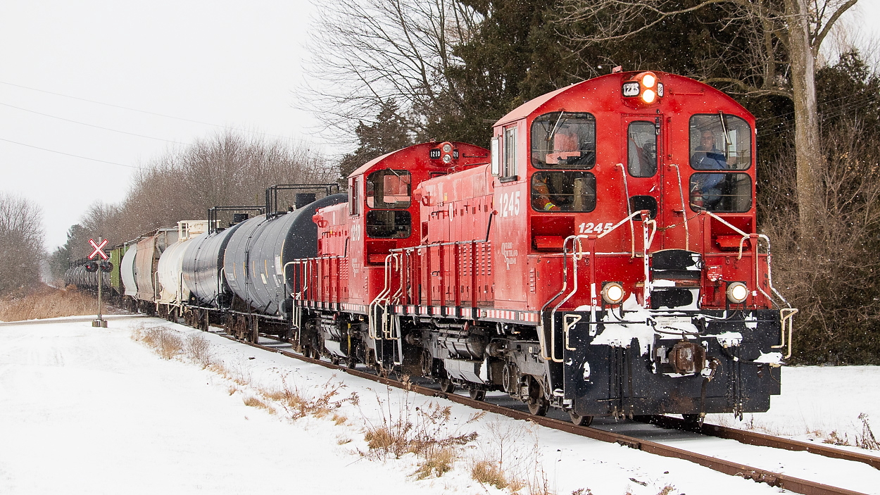 OSR is pictured here running westbound on the Cayuga, back towards St. Thomas. In tow is one tank out of the ethanol plant in Aylmer lifted on the trip east, some tanks from storage (lifted near Bayham Drive in Tillsoburg and they'd eventually lift even more in Aylmer), and empty hoppers from Courtland. In perhaps my most personally meaningful shot, I shot them in Courtland also that day, seen here.