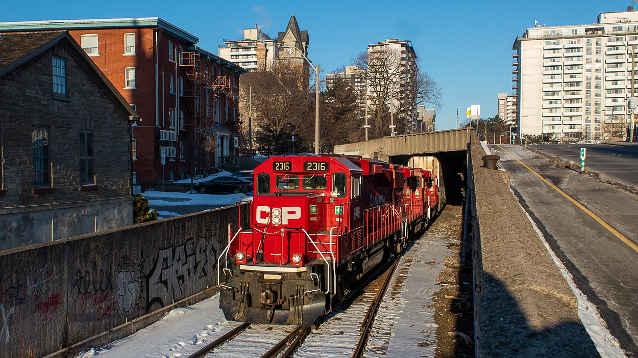 Pictured here at the Hunter Street Tunnel, a rather late 247 is getting a push up the hill as TH11's first order of business on this Thursday morning. Immediately after the morning GO trains had cleared, 247 and the crew of TH11 proceeded north on the Hamilton Sub for the journey up the hill. 247 had been in Hamilton for a while now, and had been waiting in Kinnear for 0718 to arrive, the time the last GO train departs. By the time the pushers got to me, the train had built quite a bit of speed and was rather fun to watch. Making this even more of a treat, a 2-246 was waiting at Desjardins for 247 to clear, which turned out to be a unit grain train. I shot it at Vinemount, shown here, before having to get to work. It was a good morning for railfanning the Hamilton Sub - indeed, a rare occurrence around these parts.
