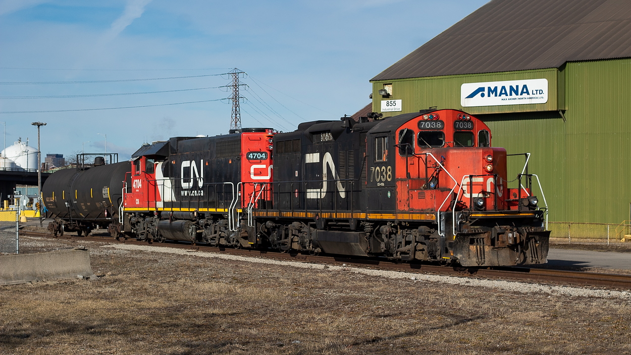 I was catching 514 leading Amtrak 64/VIA 97, when I heard the 0700 yard job call for a light down the hole. After shooting 514 at Parkdale Yard, I went out fishing for CN and found them outside of the gates for Stelco. Pictured here, the 0700 yard job is passing by MANA on its way into Stelco with a lone tank. From what I have gathered, this track was formerly known as the East Side, but I understand however that SOR referred to it as Hilton Works, and to be honest I am not quite sure what CN calls it. After dropping the tank, they lifted one lone coil and shoved back out to their train (a single boxcar for Parkdale Warehousing and a Nova Chemicals hopper) which was waiting at Irondale. CP had dropped the hopper for CN at the interchange the day prior, but I believe this was a mistake and they were supposed to actually set off a Bunge hopper. Tying onto the two cars and proceeding eastward, they dropped the erroneously delivered hopper back for CP at Adams Yard, and then went to Parkdale Warehousing to set off the boxcar. Once done there, they shoved back out with the coil car and then threw the switch for the New Gages Spur to head to Parkdale Yard. I called it a day at this point however.