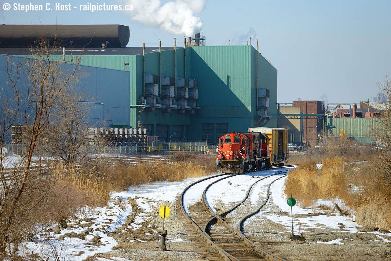 A train rounds the curve on the Kenilworth lead at the far end of the N&NW spur, with a single boxcar it looks  rather diminutive to the Dofasco factories behind them. The CN mainline here was likely re-aligned for the Ore Trains along with the Ore Train lead  constructed just around the curve of this photo. To the left is the Dofasco yard (track owned and operated by Dofasco). This is what remains of Dofasco track in this part of Hamilton the mainline once stretching from about here all the way down beyond Depew St! Their line is mostly ripped up now and what remains looks rather forlorn except for the track inside Bayfront which is still used 24/7 by bottle trains and coke oven moguls.
My first time actually shooting CN down here in the "hole" - I do miss the SOR though. Saturday Morning's yard job was switching the yard while I ran into rp.ca Moderator Ryan Gaynor. We chatted a bit while shooting the geeps switching the yard, then the geeps ran under us with a single boxcar well past any yard leads -- I knew right away they were going down the hole. Box car? Surely for Parkdale Warehousing all the way down the other end of the N&NW spur? Yup, so we got to follow all the way down in quite nice light. Not all jobs are daily, in fact, it seems weekends can be pretty quiet. We ran into James Knott down there also making for a trio of regular Hamilton guys following the action. Great to see y'all. With thanks to Tim Stevens, the Hamilton yard jobs are as follows: YHM013 - 0700. YHM303 - 1500. YHM313 - 1400. YHM603 - 2300. Not all jobs are daily but two sets of power are assigned to the yard at the present time. Weekends seem to be quiet in Hamilton but there is some action.