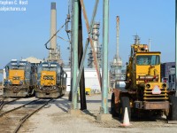 "The Moose" is the nickname for the Detroit Diesel powered Pettibone lift truck used to move materials around the yard. Perhaps some former employees can shed light to why the nickname. Two pairs of yard engines bask in the bright winter sun at the "roundhouse" (Literally what remains of the former Erie and Huron Railway roundhouse) while Imperial Oil's Sarnia refinery surround the place. Some of the refinery to the north was torn down (Lubricants plant) but still does receive rail service via CN. The CSX mainline continues about a mile north to left (with a small yard still in use called Lower Yard) and behind that smokestack and ends at a CN Connector by Divine St - according to track diagrams the end of line was where Confederation St once crossed the line (removed by plant expansion a few decades ago, all now demolished!). The last time the north interchange was used was 2013 when there was troubles on the reserve . I enjoy the gritty, industrial scenes of Sarnia.  You have to work around the pipeline bridges and other objects, and security watching you as you take photos and sometimes following you around :)



