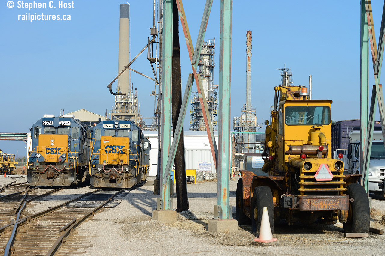 "The Moose" is the nickname for the Detroit Diesel powered Pettibone lift truck used to move materials around the yard. Perhaps some former employees can shed light to why the nickname. Two pairs of yard engines bask in the bright winter sun at the "roundhouse" (Literally what remains of the former Erie and Huron Railway roundhouse) while Imperial Oil's Sarnia refinery surround the place. Some of the refinery to the north was torn down (Lubricants plant) but still does receive rail service via CN. The CSX mainline continues about a mile north to left (with a small yard still in use called Lower Yard) and behind that smokestack and ends at a CN Connector by Divine St - according to track diagrams the end of line was where Confederation St once crossed the line (removed by plant expansion a few decades ago, all now demolished!). The last time the north interchange was used was 2013 when there was troubles on the reserve . I enjoy the gritty, industrial scenes of Sarnia.  You have to work around the pipeline bridges and other objects, and security watching you as you take photos and sometimes following you around :)