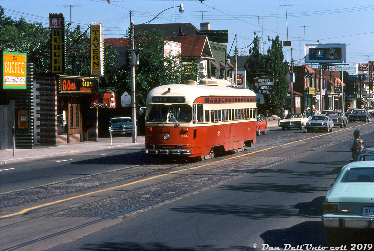 During the last week of regular streetcar operation on Mount Pleasant Avenue, TTC A8-class PCC 4527 heads northbound on the Mount Pleasant route, approaching Eglinton Avenue and the route's northern terminus at Eglinton Loop. It's Thursday July 22nd 1976, and after the curtain falls on streetcar operation the route would switch to trolleybus operation as the Route 74 a year later (diesel shuttle buses would run for an interim period during a bridge reconstruction along the route, that was part of the decision to end streetcar service). The last streetcar to run along Mount Pleasant would be a Sunday Peter Witt charter a few days later. The 4500-series A8's were the newest cars on the system (built 1951) and based out of Wychwood (St. Clair) carhouse, which operated the Mount Pleasant route as well as others including St. Clair. 

J. Bryce Lee photo, Dan Dell'Unto collection.