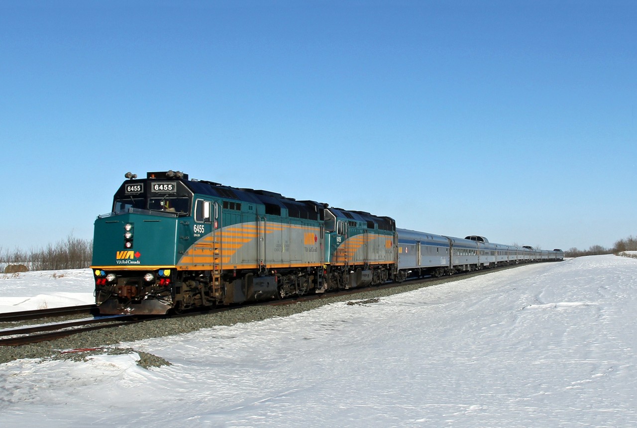 On a bright but cold day, -25C, VIA 6455 and 6439 lead their short winter train west at Lindbrook